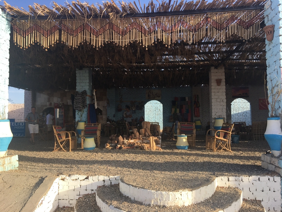 Espace extérieur avec mobilier en bois sous un auvent.