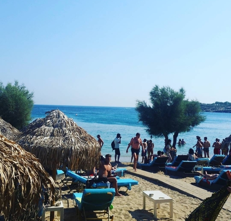 Beach scene with people enjoying the sun.