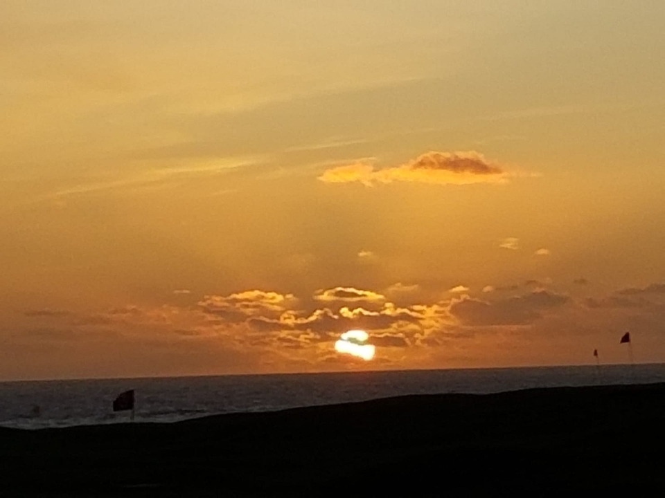 Coucher de soleil sur l'océan avec des nuages.