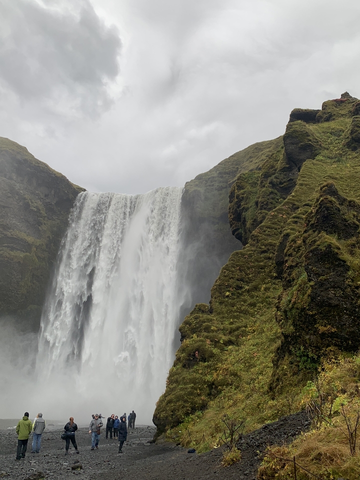 Waterfall cascading down moss-covered cliffs.