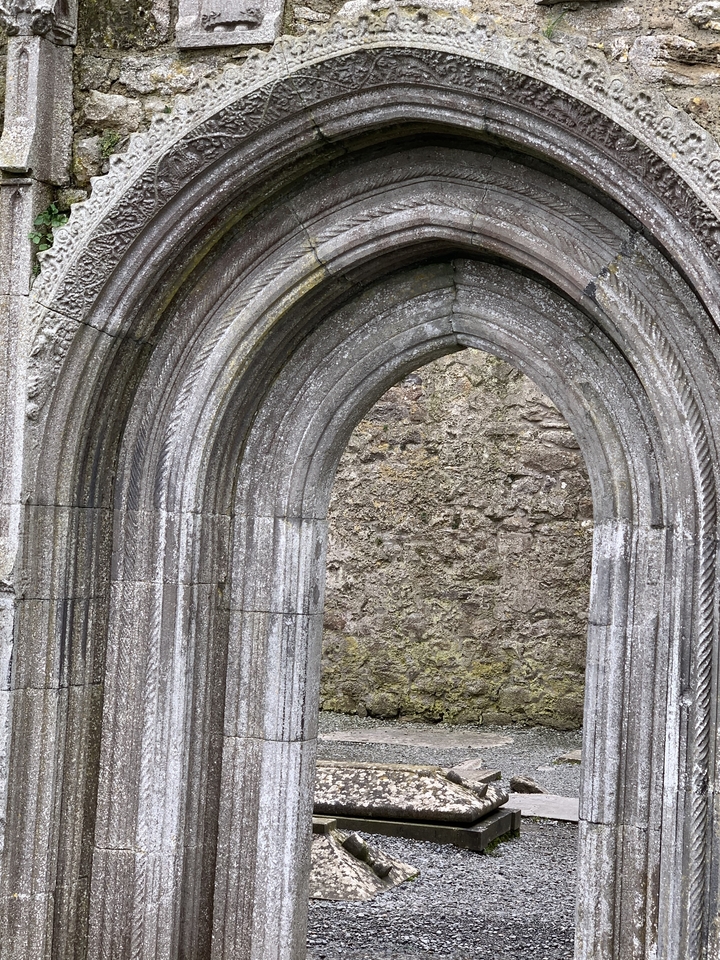 Arche en pierre avec des sculptures complexes.