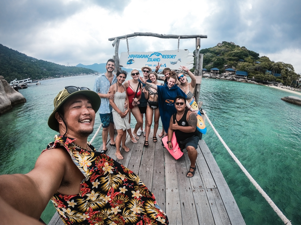 Group photo on a wooden bridge over water.