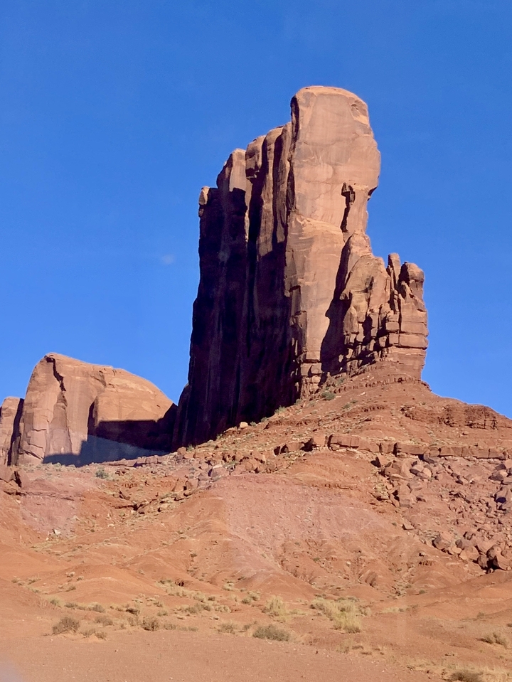 Formations rocheuses de Monument Valley avec ciel bleu.