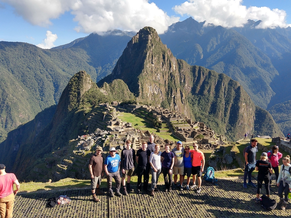 Un groupe de personnes posant devant le Machu Picchu.