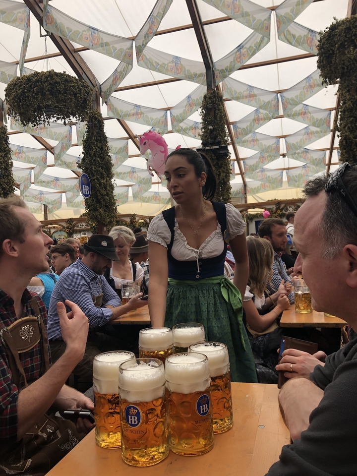 Une serveuse servant de la bière dans une brasserie animée.