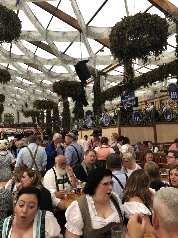 Foule dans une grande brasserie avec décorations.