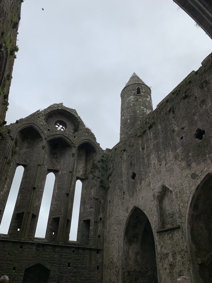 Ancient stone church ruins with a round tower.
