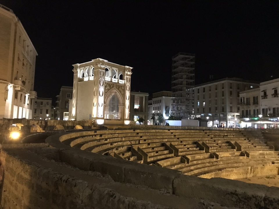 Un amphithéâtre illuminé et une architecture historique la nuit