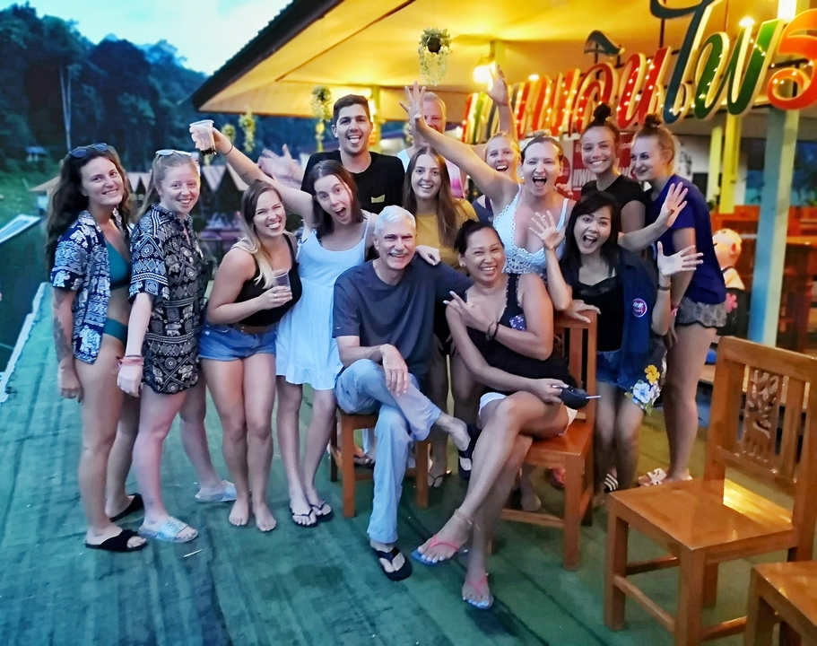 Large group of people smiling and posing at a party setting.