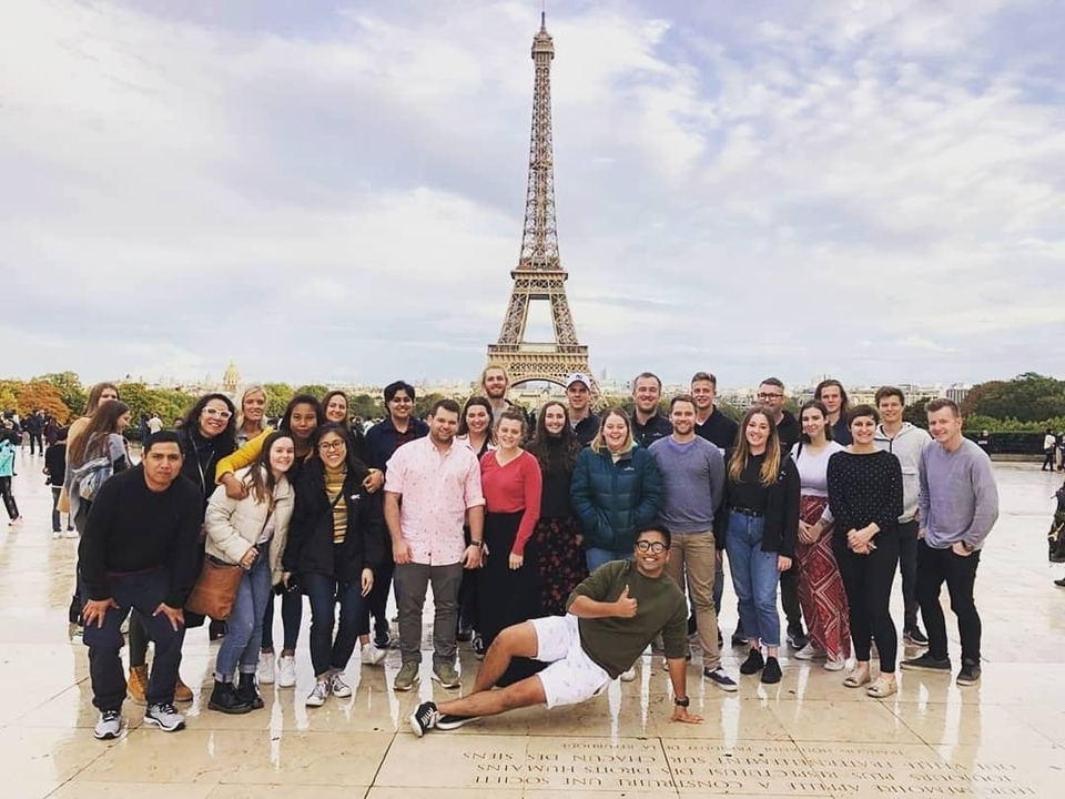 Large group with Eiffel Tower in the background.