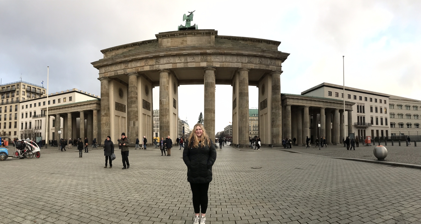 Person standing in front of Brandenburg Gate.
