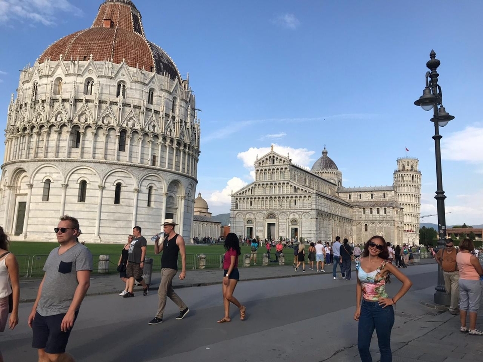 Pisa Cathedral and Leaning Tower with many visitors.