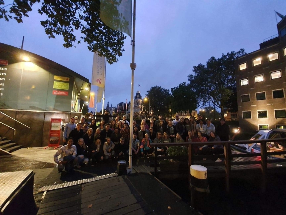 Photo de groupe sur un quai pendant la nuit.
