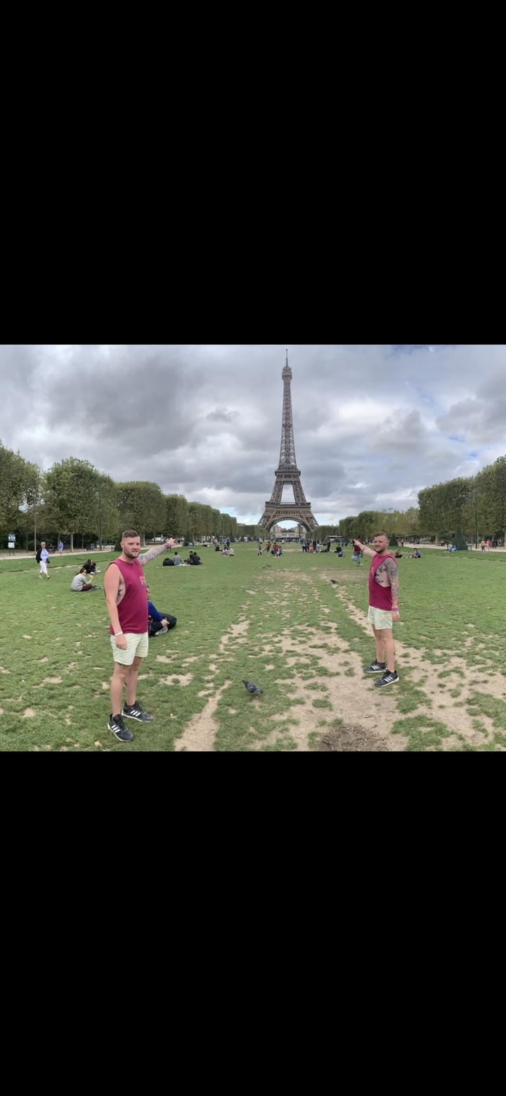Deux personnes pointant vers la tour Eiffel à Paris.