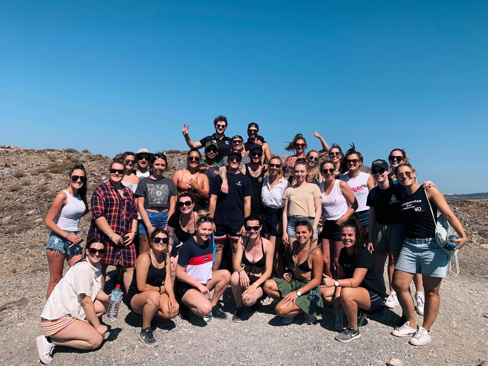 Photo de groupe de personnes souriantes par une journée ensoleillée.