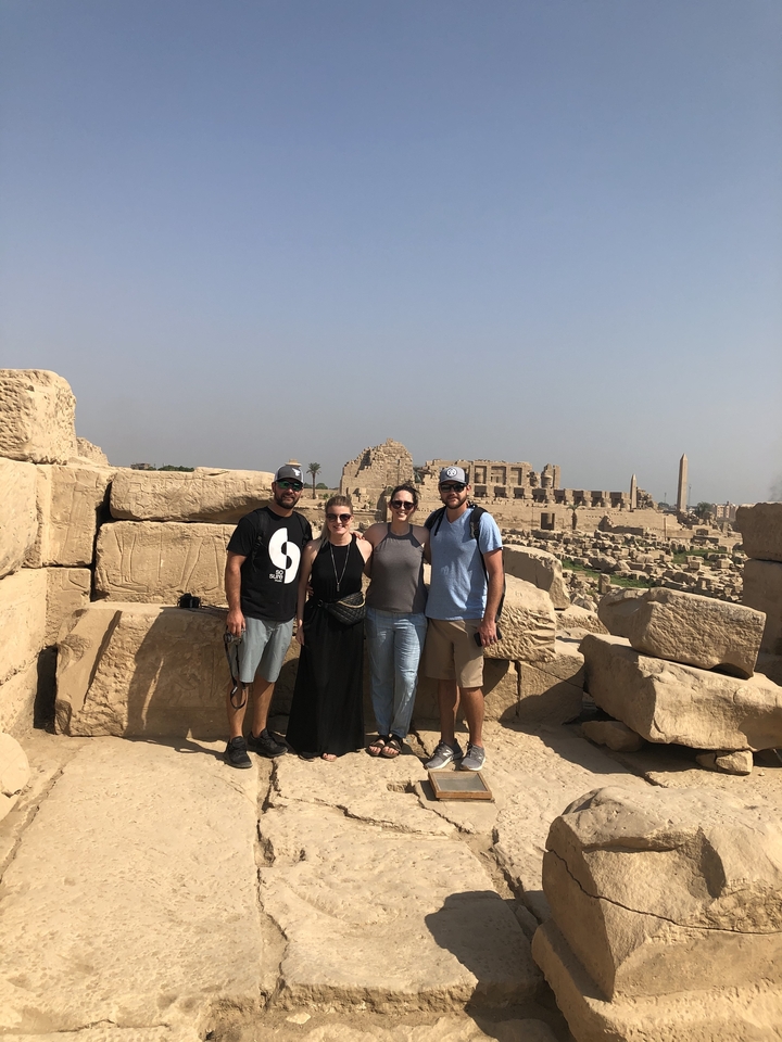 Groupe de touristes sur un site antique avec des ruines.
