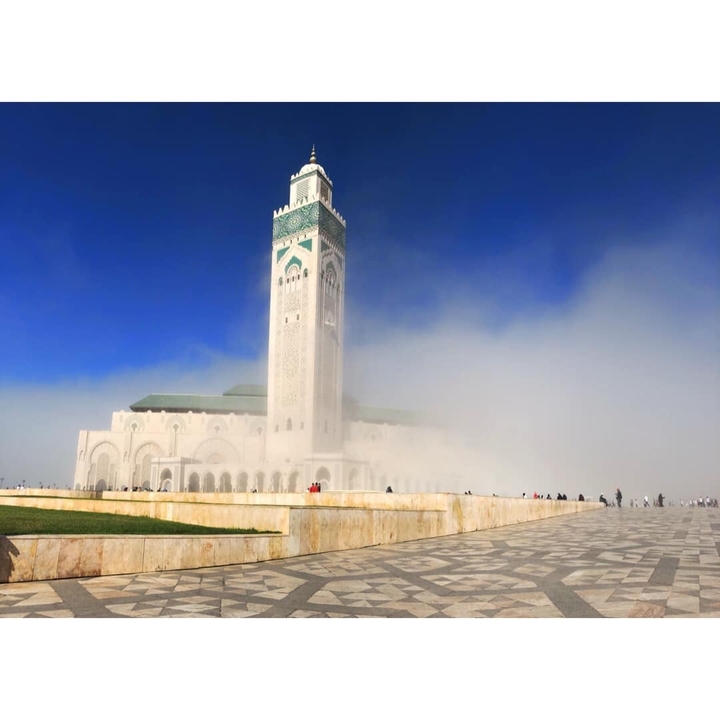 Hassan II Mosque partially obscured by mist.