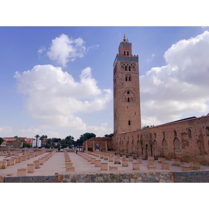 Historic mosque tower with open plaza.