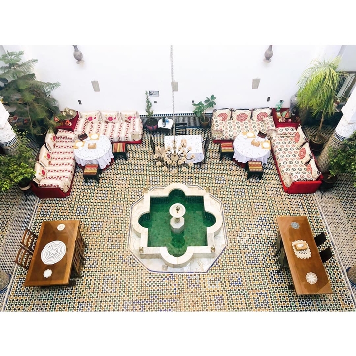 Traditional Moroccan interior courtyard with a central fountain.