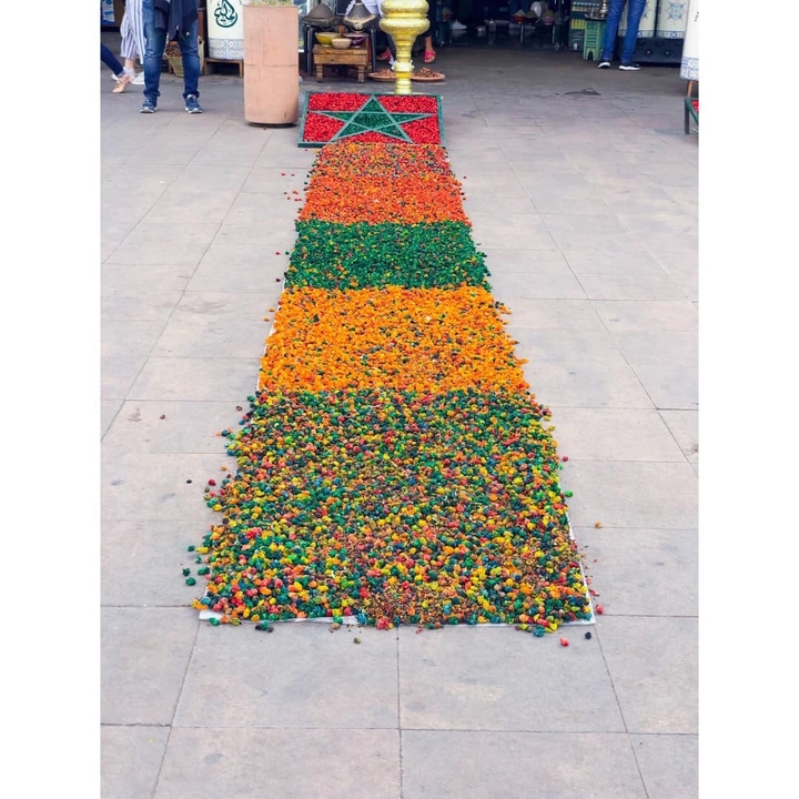 Colorful floral design arranged on the ground.