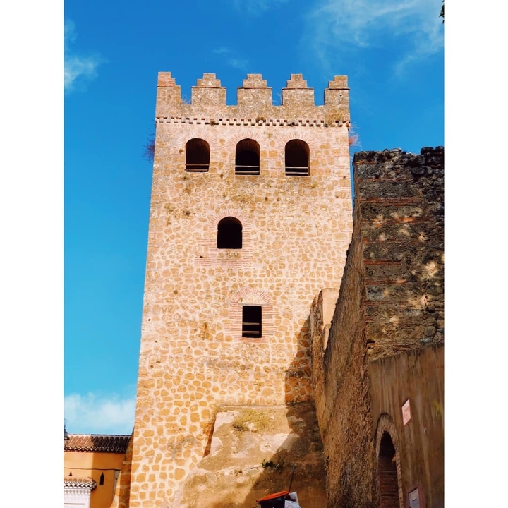 Historic stone tower with arched windows.