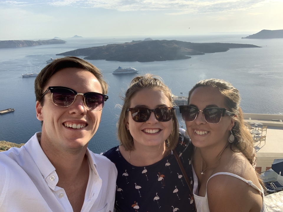Three friends taking a selfie with a sea view.