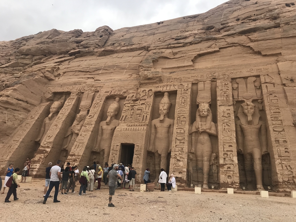 Des touristes explorant l'extérieur d'un temple égyptien.