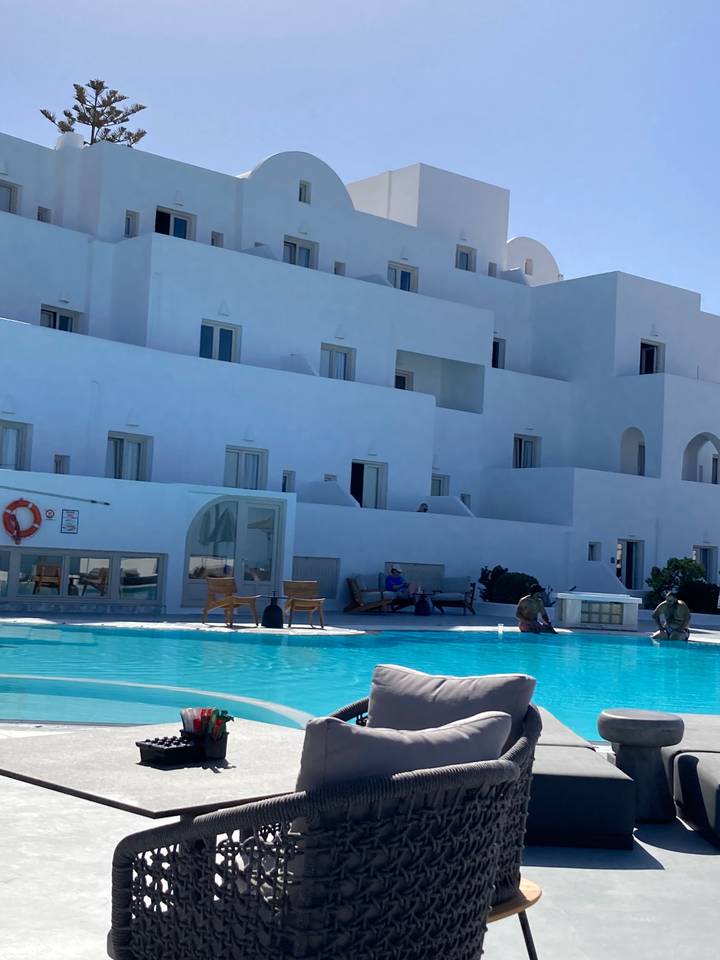 Station balnéaire avec piscine et bâtiment blanc.