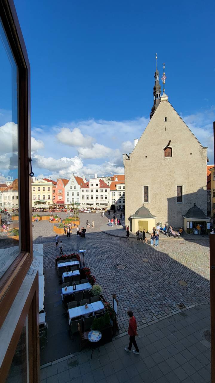 A view of a square with historic buildings and people.