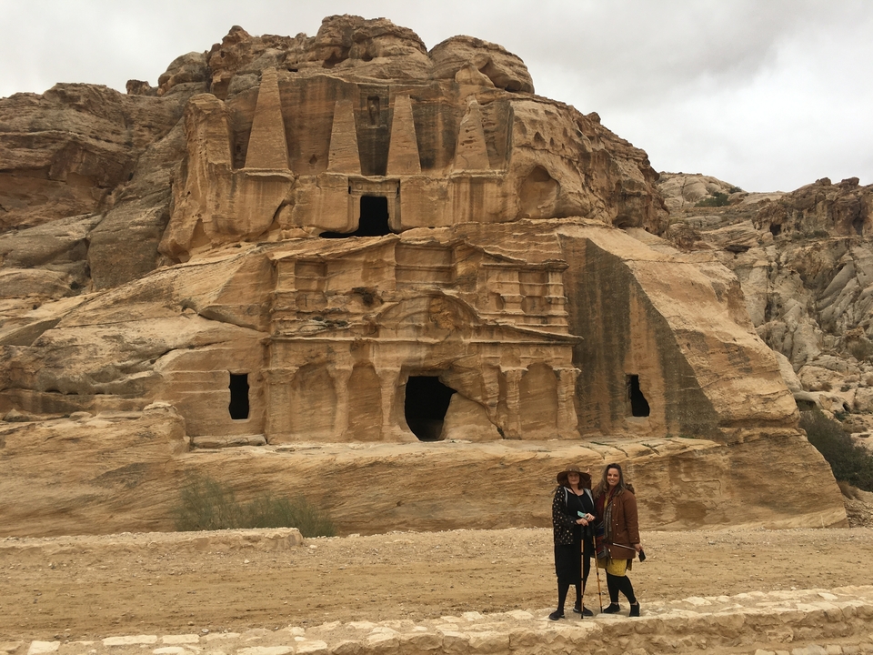 Deux femmes posant devant l'architecture taillée dans la roche de Pétra.