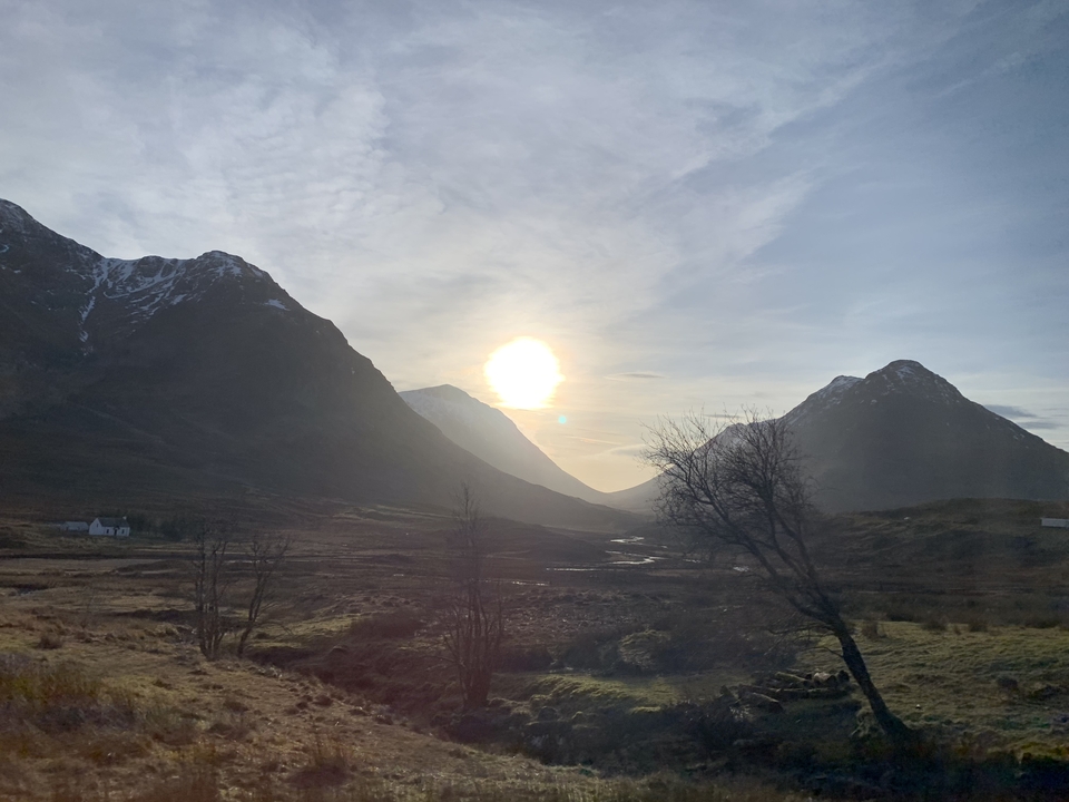 Scenic view of mountains during sunset with some trees.