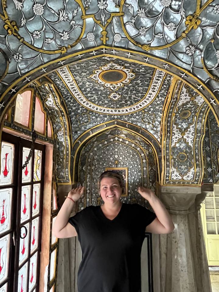 Personne posant devant un plafond au design complexe.