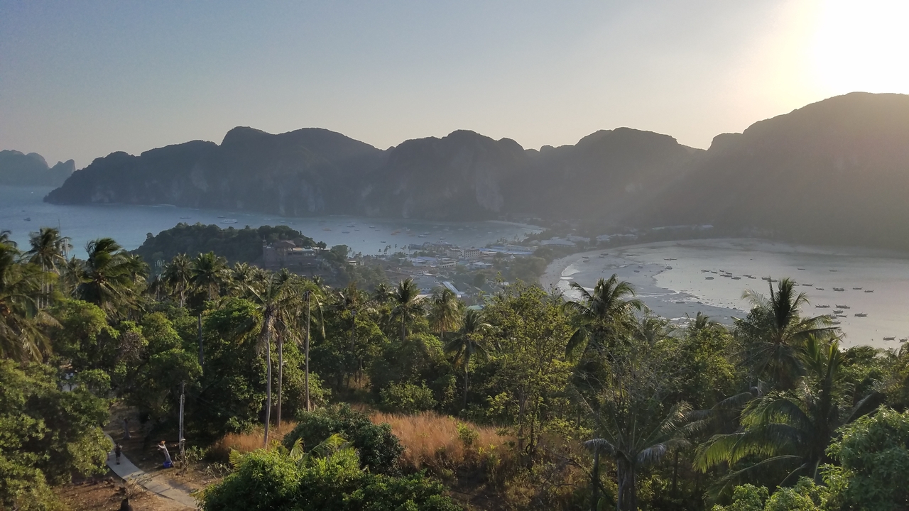 Aerial view of a tropical island with dense forests and beaches.