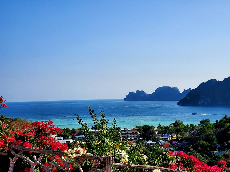 Scenic view of a bay with vibrant water and rocky islands.