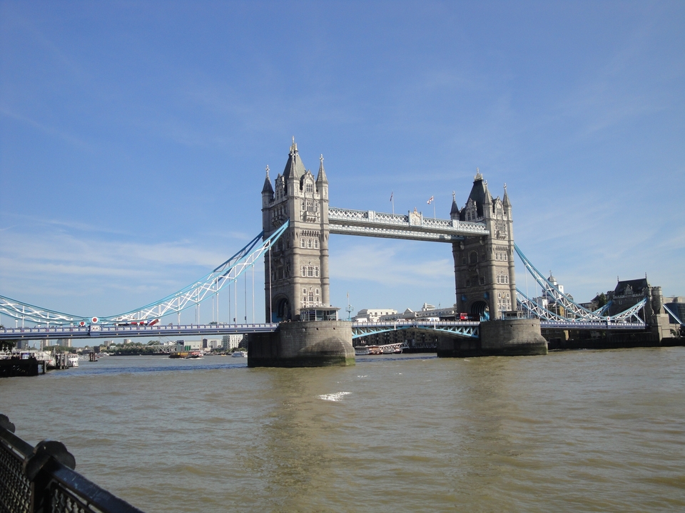Tower Bridge over the Thames with a clear blue sky.