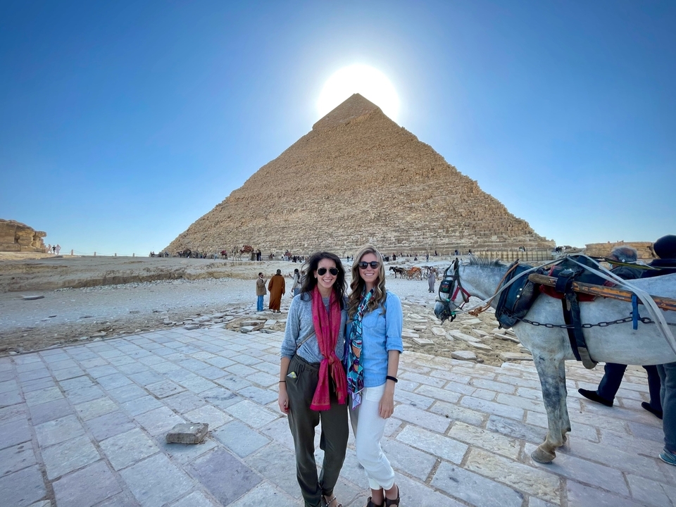 Deux personnes devant une pyramide avec un cheval.