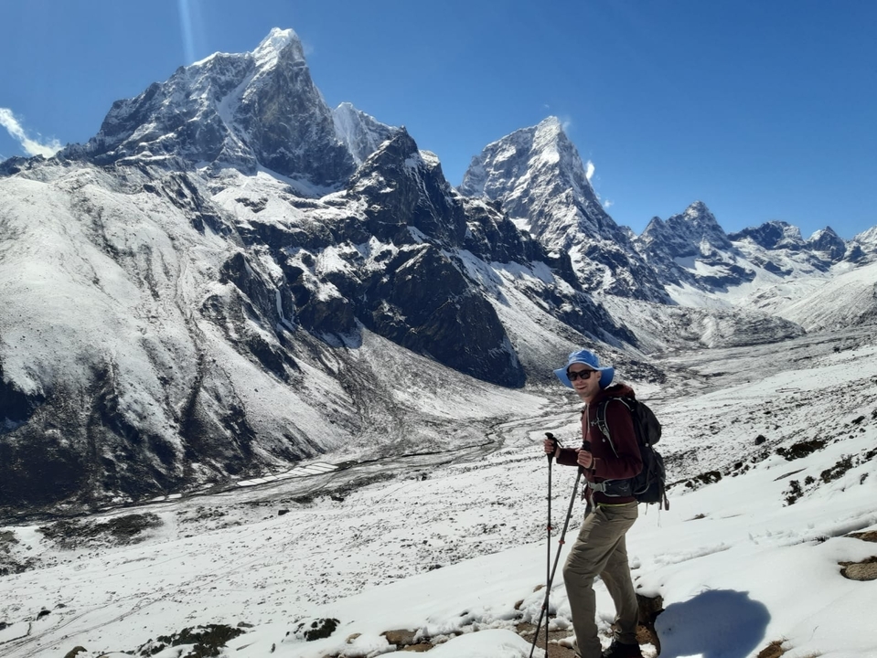 Person hiking in snowy mountains.