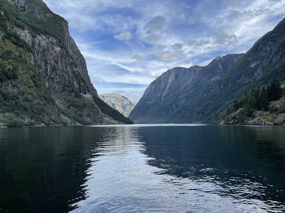 Fjord serein entouré de hautes montagnes.