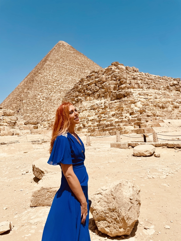 Personne devant les pyramides avec un sourire.