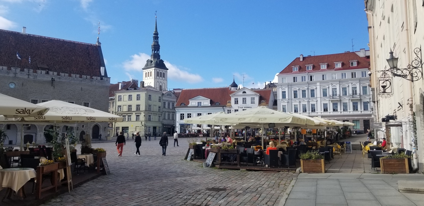 Des gens qui marchent sur une place pavée de la ville avec des bâtiments historiques