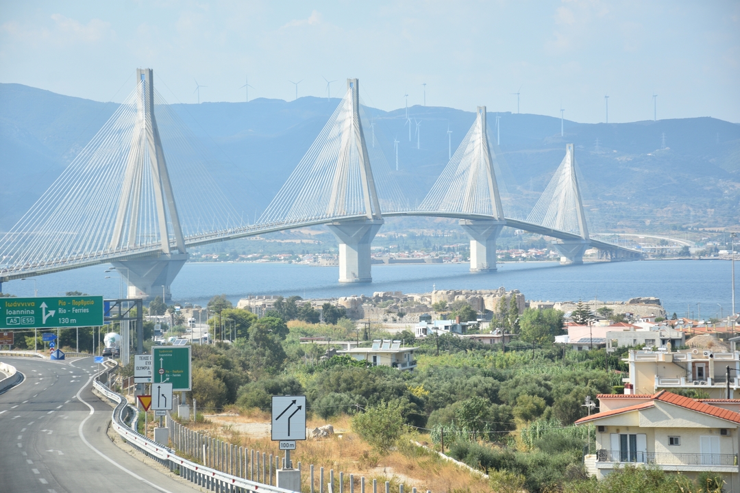 Elegant cable-stayed Rio–Antirrio Bridge spans blue waters with mountains behind