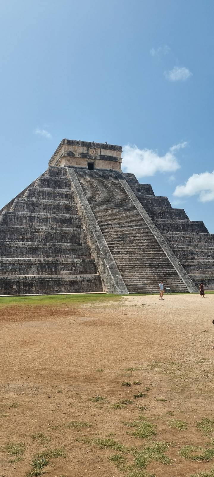 La pyramide à degrés emblématique de Chichen Itza sous un ciel bleu.