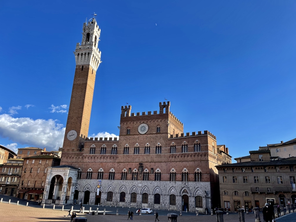 Un bâtiment historique avec une tour d'horloge sous un ciel bleu dégagé.