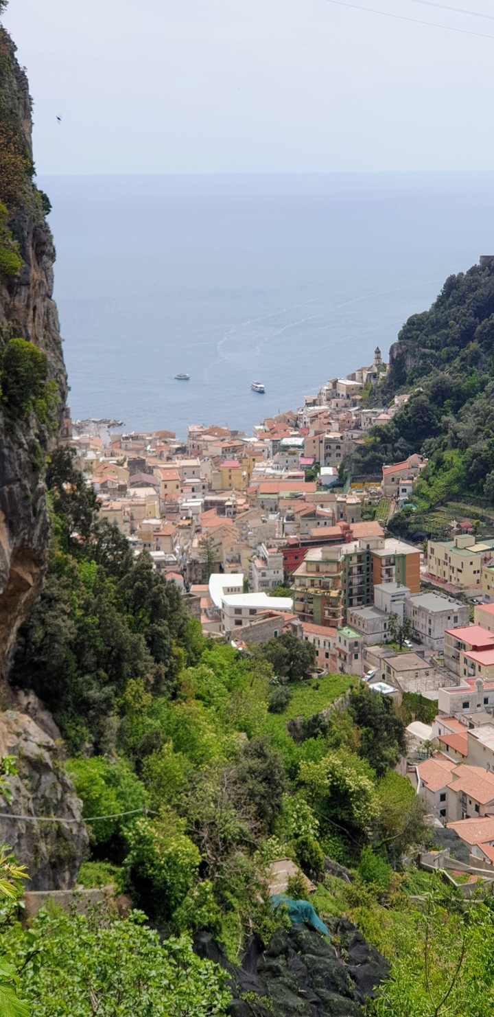 A scenic view of a coastal town with colorful buildings by the sea.