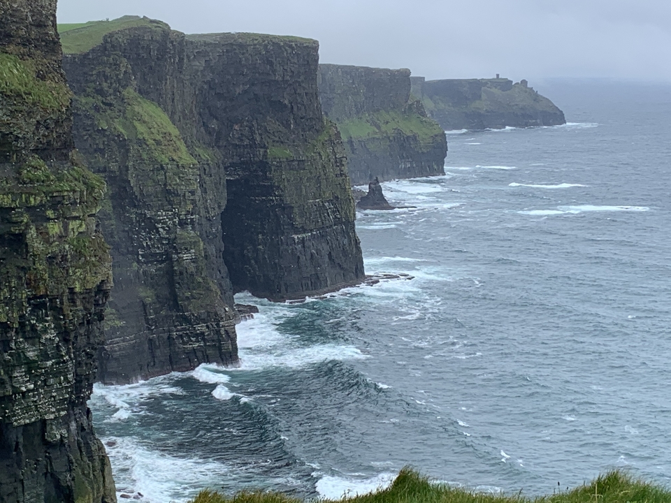 Cliffs of Moher with waves crashing below.