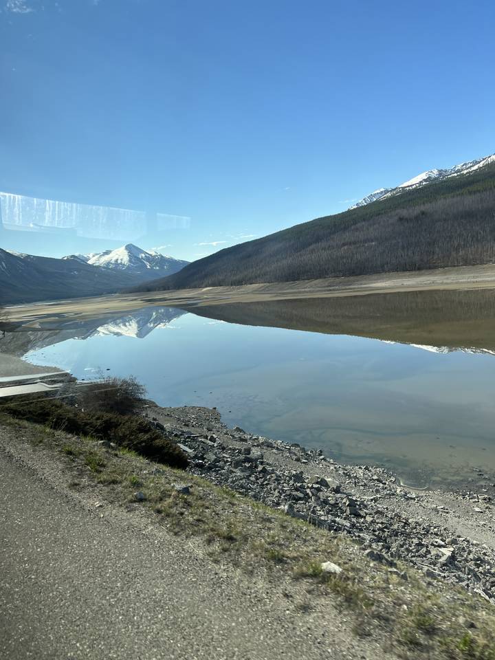 A scenic view of a mountain reflected in a body of water.