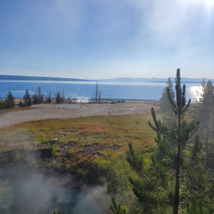 Lac avec montagnes lointaines et une promenade en planches dans un parc national.