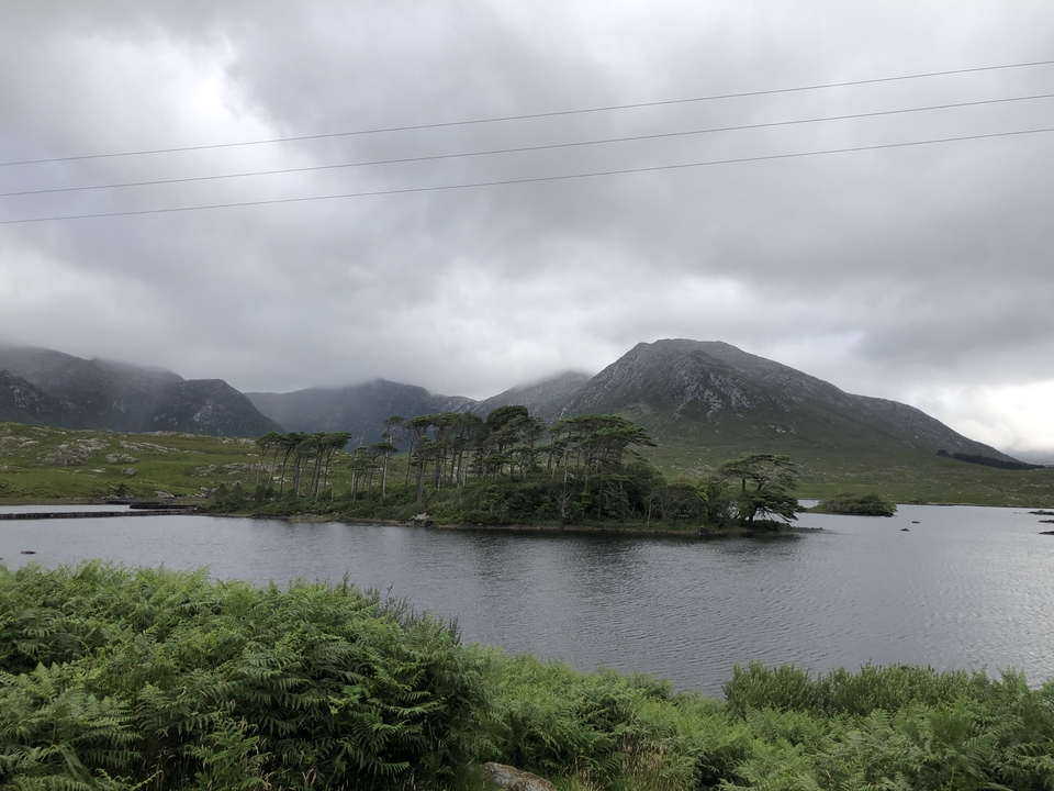 Lake with small island and distant mountains.