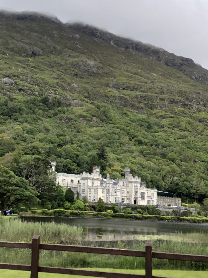 Castle surrounded by lush green hills.