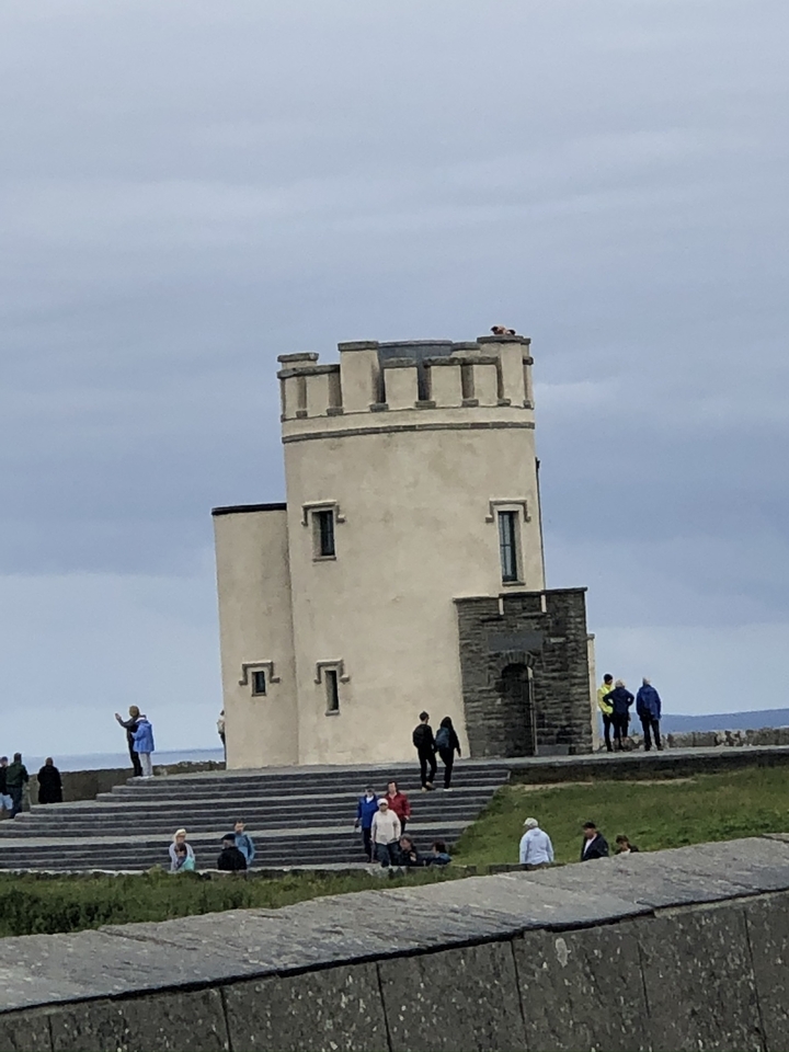 Stone tower with people and panoramic views.